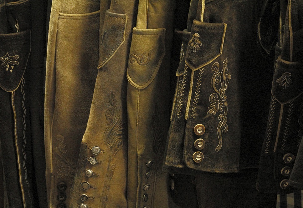 Four Steps to Bring your Old Lederhosen into Life 1 Close-up of embroidered traditional Bavarian Lederhosen hanging on a rack. - Lederhosen For Sale