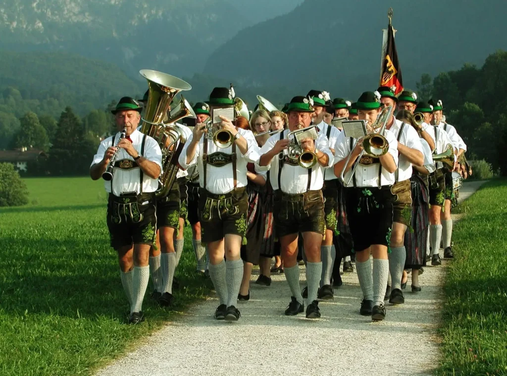 Bavarian brass band marching in traditional Lederhosen clothing - Lederhosen For Sale