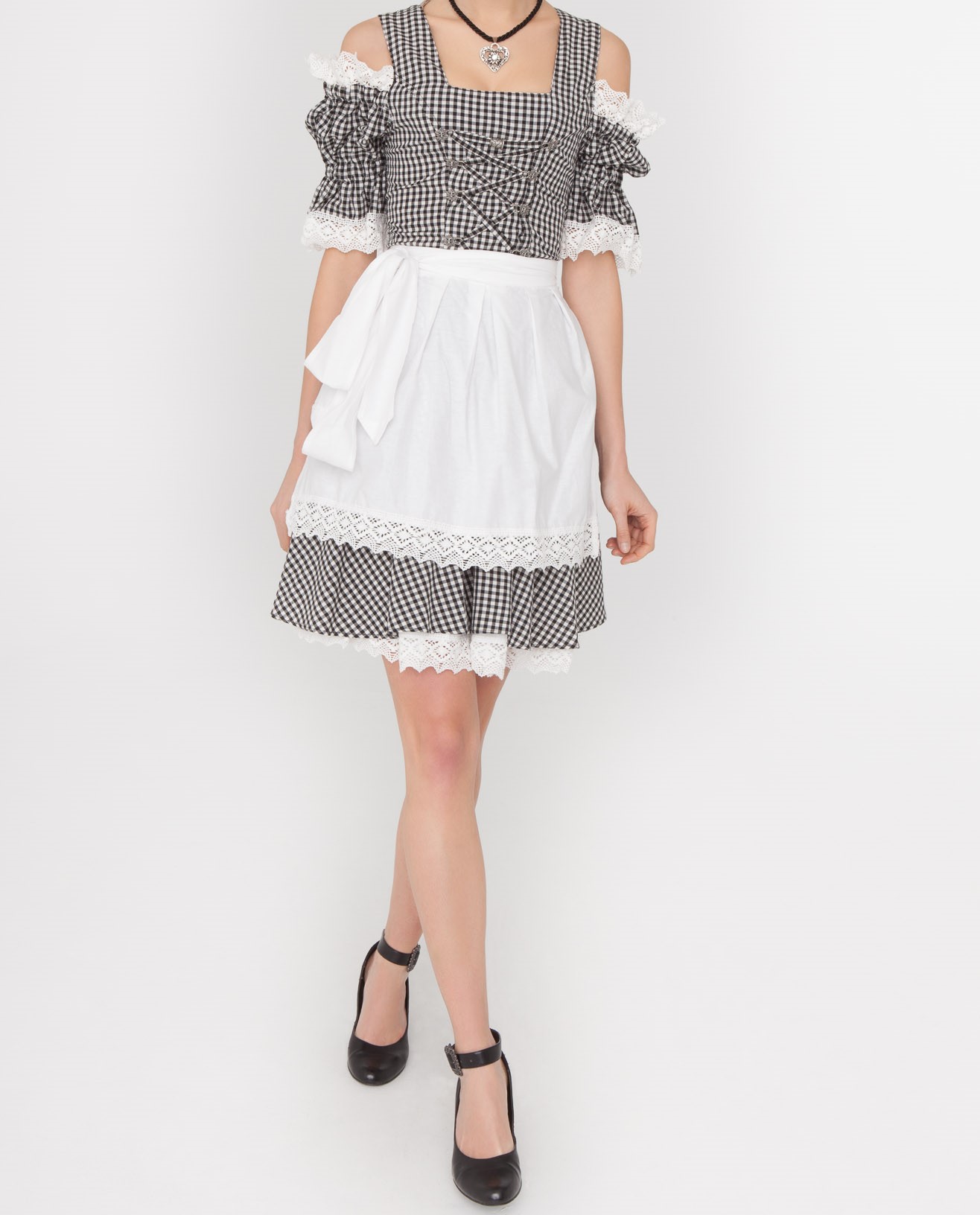 Dirndl Mara 1 Woman posing in black checkered Dirndl with white apron. - Lederhosen For Sale