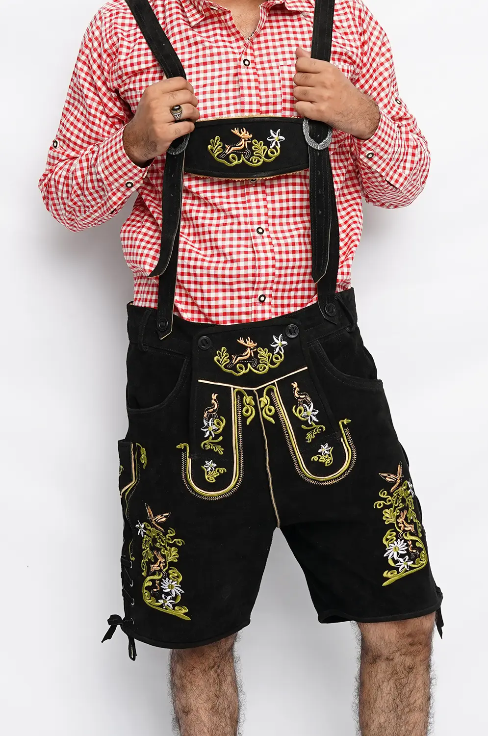 Close-up of black leather Lederhosen with green stag embroidery and a red checkered shirt. - Lederhosen For Sale