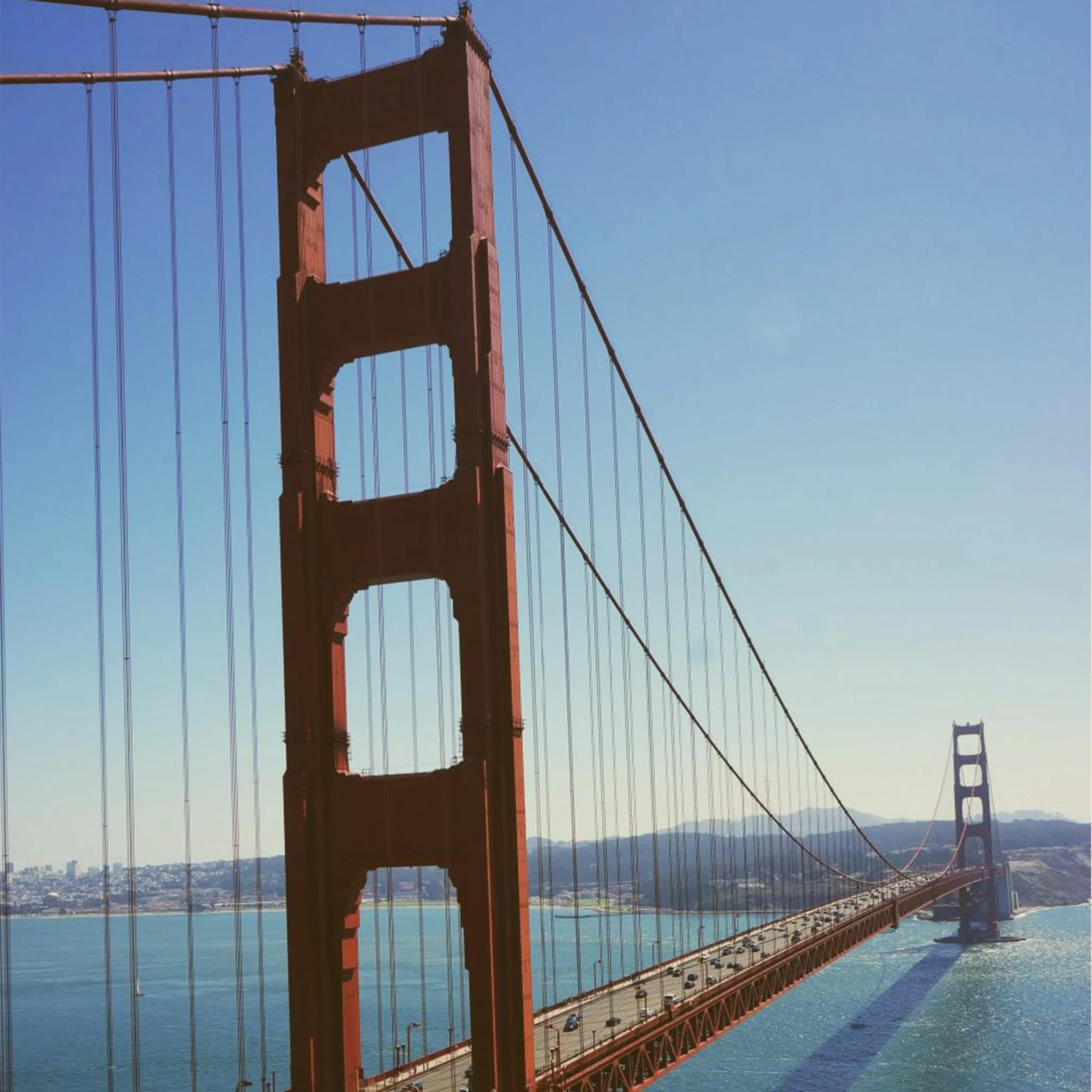 Golden Gate Bridge under a clear blue sky, looking down the span toward San Francisco. - Lederhosen For Sale