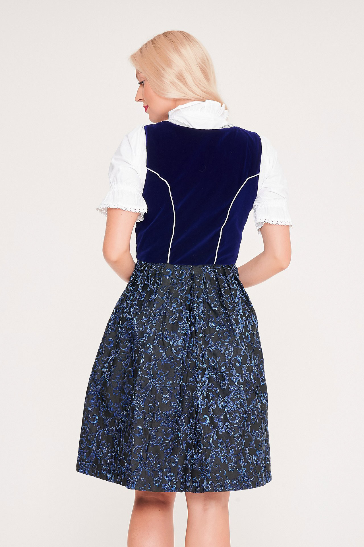 Back view of blonde woman in dark blue Dirndl. - Lederhosen For Sale